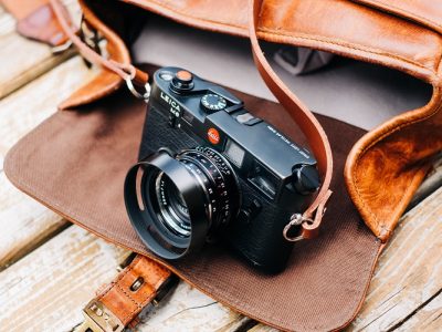 camera with brown leather bag